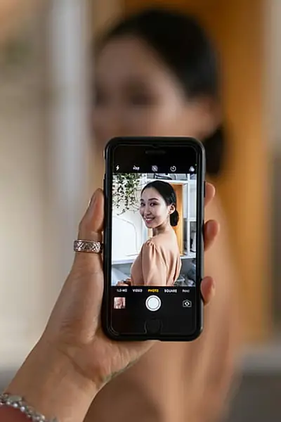 Woman taking a selfie with her smartphone front camera